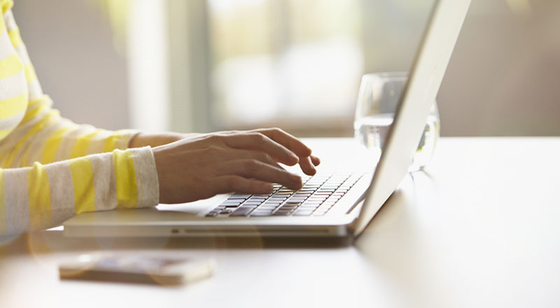 Woman typing on her laptop